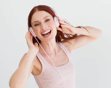 Woman, headphones and studio portrait with smile for music, streaming subscription or podcast by background. Isolated girl, student or model with happiness for audio, sound and internet radio by wall