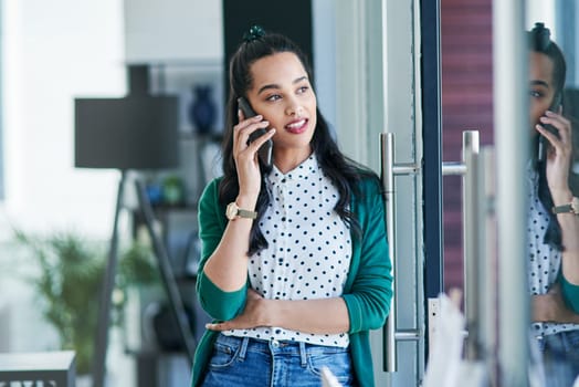 Get connected and give your new business venture a voice. a young businesswoman using a smartphone in a modern office.