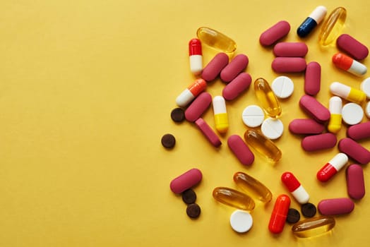 How much is too much. Studio shot of an assortment of medication against a yellow background.