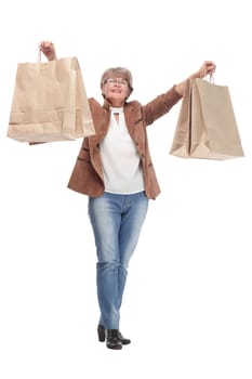 Mature woman holding bags smiling and looking at camera