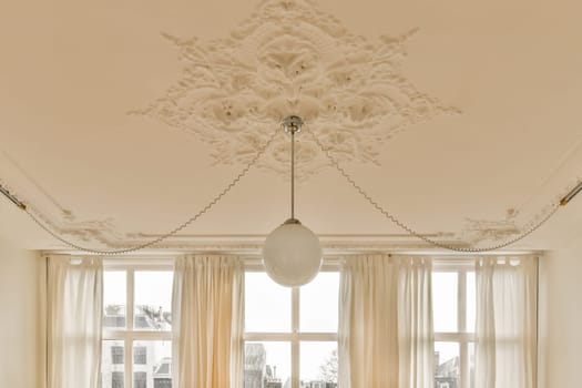 the ceiling of a living room with a white lamp