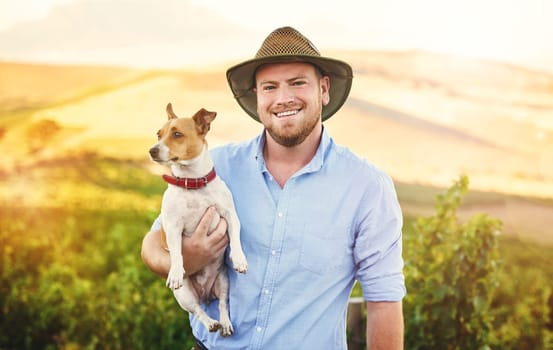 I would choose country life over city life any day. a happy farmer holding his dog.