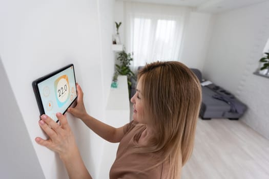 Woman using smartphone to control home connectivity interface