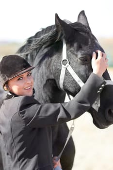 Horse rider, trainer portrait and woman on equestrian training and competition ground. Outdoor, female competitor and show horses stable with a girl smile stroking an animal before riding with helmet