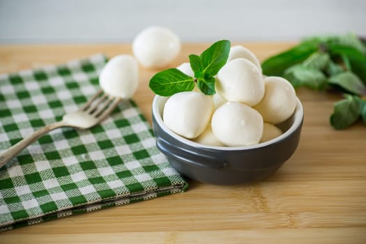 Small balls of traditional mozzarella in a ceramic bowl