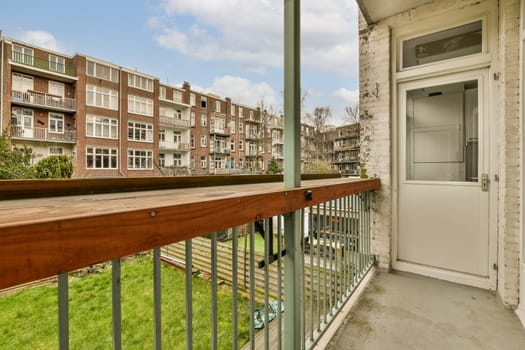 a balcony with a wooden rail and a door to