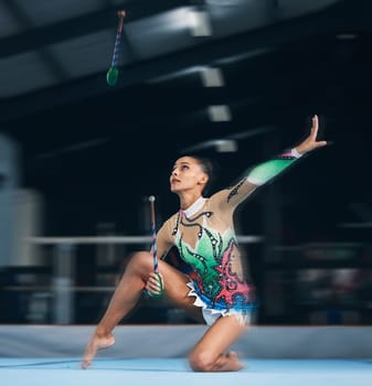 Woman, gymnast and dance sticks with balance and focus in a gym for dancing performance art. Exercise, training and sports competition of an athlete with moving for show for fitness and dancer sport.