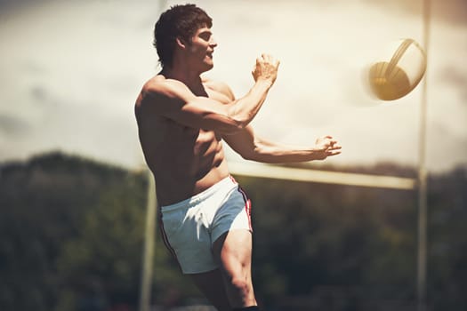 Shirts vs. Skins. a shirtless rugby player executing a pass during a game.