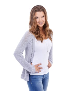 Beauty in blue jeans. A young woman in casual wear standing against a white background and smiling at the camera.