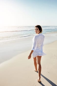 Romance me with walks on the beach. a beautiful young woman enjoying her day at the beach.
