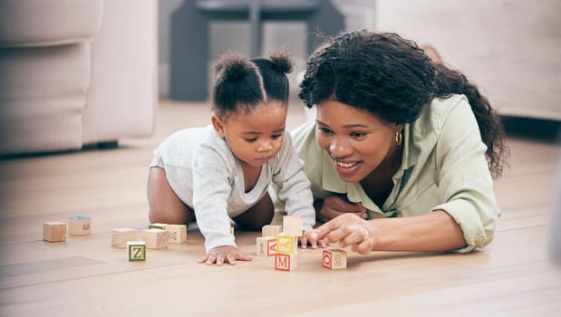 Baby, mother and toy building blocks for child knowledge development on living room floor. Family home, teaching and mom with girl toddler learning and helping with happiness and a smile with love