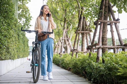 woman commute on smartphone with bicycle on summer in park countryside