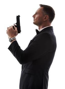 Spy man, profile and gun with suit for undercover mission, justice or espionage by white background. Government agent, detective and weapon in studio with designer tuxedo, secret information and work