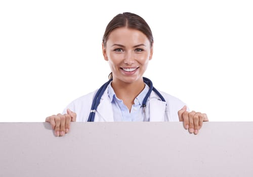 Endorsing your medical product. A beautiful young doctor holding a blank placard and smiling at the camera.