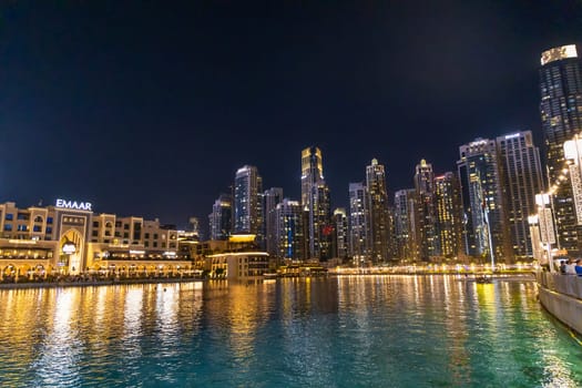Dubai city skyscrapers in the evening in the lights. Travel concept. Dubai, UAE - April 30, 2023.