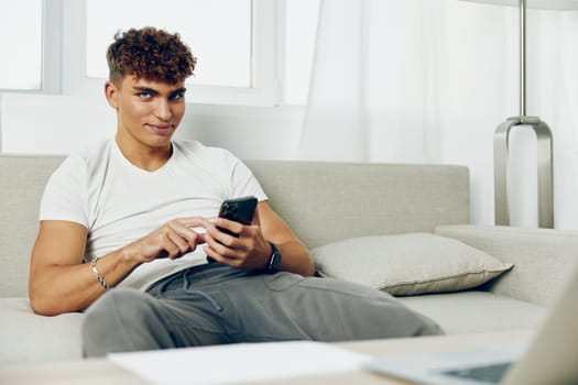 man interior smart using smartphone mockup selfies person cellphone couch smile mobile internet male phone sitting cyberspace online communication holding