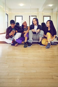 Dance fam. a group of young friends hanging out in a dance studio.