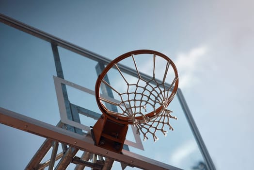 Aiming high. Closeup shot of a basketball hoop on a sports court.