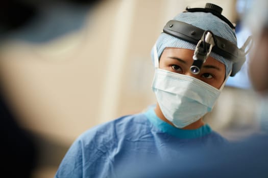 Surgery is a serious business. a surgeon performing a surgery in an operating room.