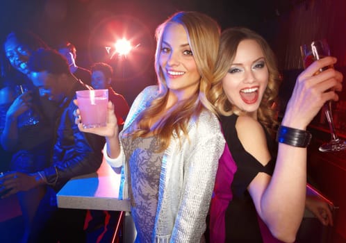 Party, friends and alcohol drinks at a nightclub while dancing, happy and excited to celebrate birthday, new years or happy hour together. Portrait of women with cocktails for a celebration at a club