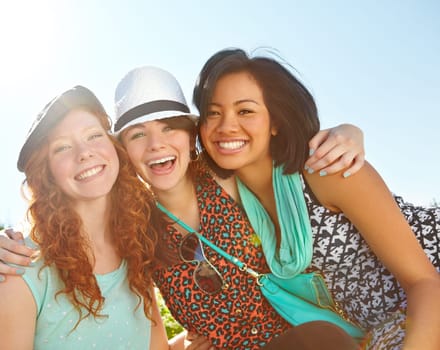 What is life without girlfriends. Three teenage girls smiling happily with their arms around each other.