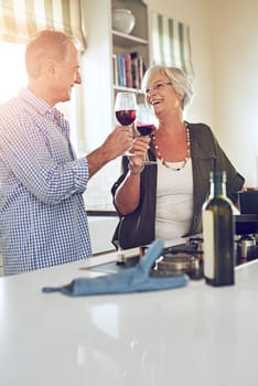 Toast, wine or happy old couple in kitchen in celebration of marriage anniversary together in retirement at home. Cheers or senior woman drinking or bonding in a house with mature husband at dinner