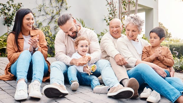 Family, generations and love, relax on lawn with happy people, grandparents with parents and children outdoor. Happiness, unity and support with care, together at home with bonding and diversity