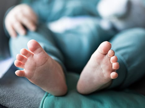 Close-up of cute little baby feet, innocence concept.
