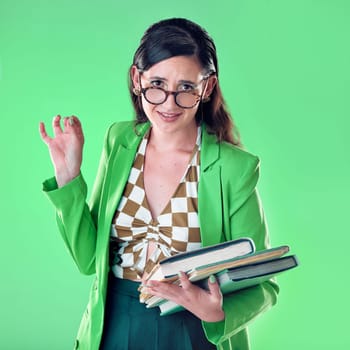 Confused, elegant and portrait of a woman with books isolated on a green background in a studio. Classy, education and girl doing college research, studying and reading while frustrated on a backdrop.