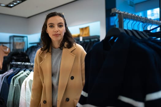 Woman choose what to buy in clothes store