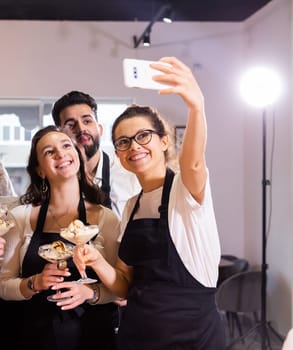 Students in cookery class taking selfie after cooking - friends and social media concept