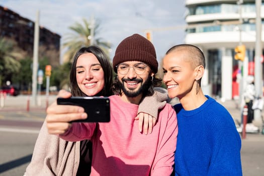 three young friends taking a selfie photo in the city, concept of friendship and urban lifestyle