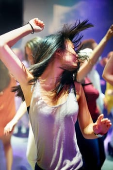 Shot of an attractive woman dancing to the music. This concert was created for the sole purpose of this photo shoot, featuring 300 models and 3 live bands. All people in this shoot are model released.