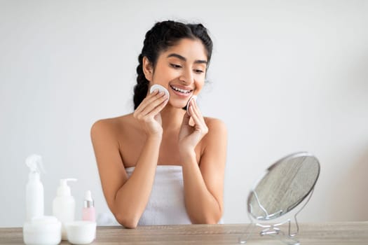 Skincare Routine. Attractive Young Indian Woman Cleansing Skin With Cotton Pads