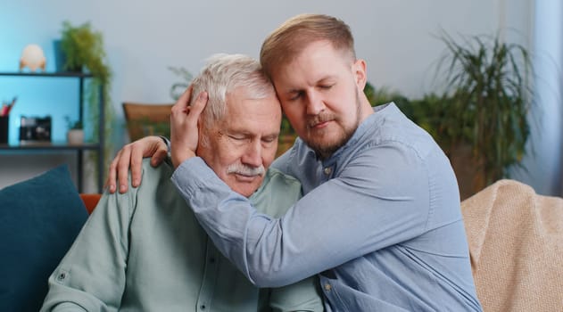 Adult man grandson supporting, giving psychological help to ill sick senior grandfather, compassion