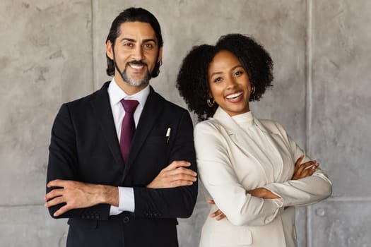 Cheerful middle eastern man and black woman managers, office interior