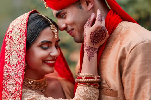 Wedding, marriage and hand henna with couple together in celebration of love at a ceremony. Happy, romance or islamic with a husband and wife getting married outdoor in tradition of their culture