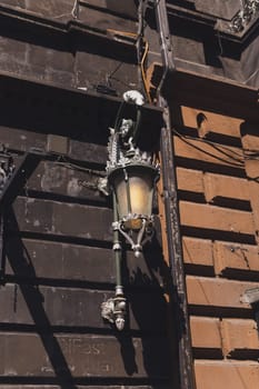 Old fashioned street lamp. Decorative lamps on building in the street