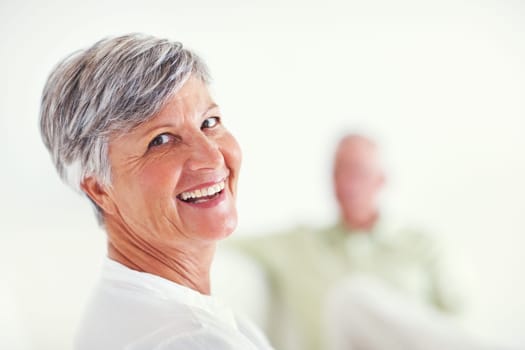 Happy mature woman with man. Portrait of happy mature woman having happy time with man in background.