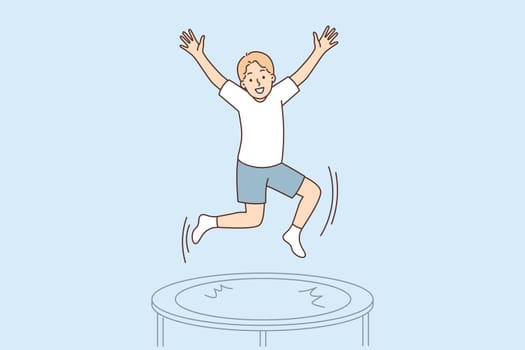 Teenage boy jumps on trampoline enjoying outdoor activities and exercising in gym
