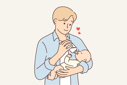 Man feeds newborn baby experiencing fatherly love for baby for concept of equal parenting