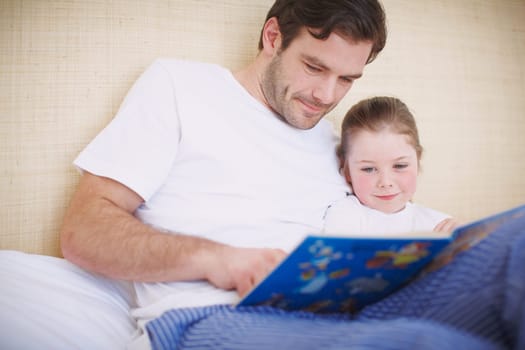 Once upon a time...A devoted father reading his young daughter a bedtime story.
