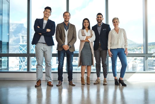 Success is ours to take. Portrait of a diverse group of businesspeople standing in an office.