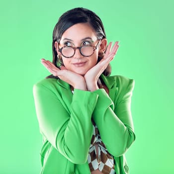 Woman, teacher and hands on face with green screen, studio background and thinking with vision for career. Young model, education and ideas with glasses, mockup and with fashion, pride and happiness