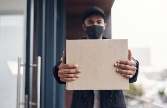 Were delivering your goods a little different these days. a masked young man delivering a package to a place of residence.