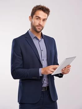 Business man with tablet in portrait, technology and communication for company isolated on studio background. Internet, connectivity and networking, professional male with tech and corporate career.