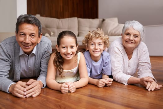 Portrait, relax or grandparents on the floor with happy kids smiling together in family home in retirement. Senior grandma, smile or fun children siblings bonding to enjoy quality time with old man