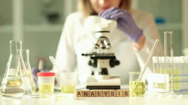 Doctor of laboratory diagnostics making general urine analysis in chemical lab closeup