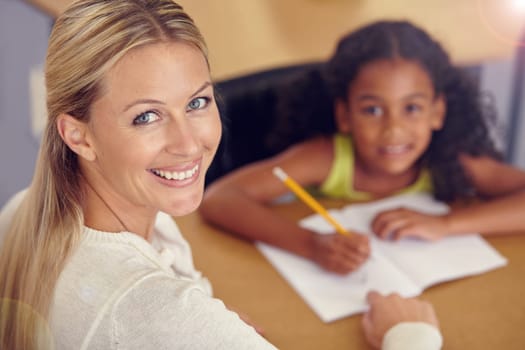 Portrait, woman and kid to learn for reading on desk in the classroom for studying. Teacher, smile and child learning for student with education at school to study with support or writing on a table.