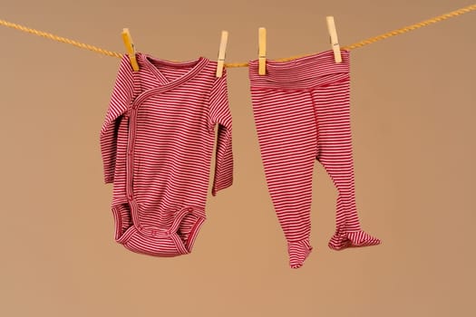 Kid's apparel pinned to a clothesline to dry